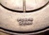 This is the back side of an emblem and shows the supplier's mark.