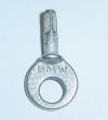 This key opens the tool box that is on top of many BMW motorcycles. It is a casting that is plated.