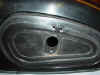 This photo shows the front of a small tank BMW motorcycle tool box lid with the lock removed.