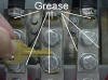 These are properly greased terminals in a cellular telephone (radio station) site. The key is for size reference. See the bead of light brown grease that has squeezed out and around the terminals? If you look closely you can also see the upper part of the terminal where the black cable goes into the terminal. Look just below the crimp and you can see a "window" or hole in the terminal. You can see some grease squeezed out through the hole. That is for me, the inspector, to be able to determined that the cable was fully greased before the terminal was crimped. All copper wire should be greased before the terminal is crimped. 